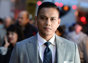 Person looking serious in a three-piece suit on a city street