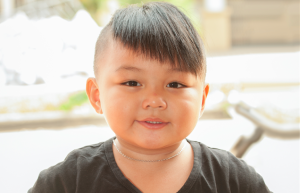 A young child with a funky haircut